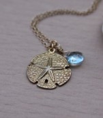 Gold Sand Dollar Necklace With Blue Topaz Gemstone