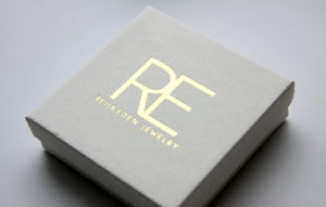 gold and white jewelry packaging by Reija Eden Jewelry